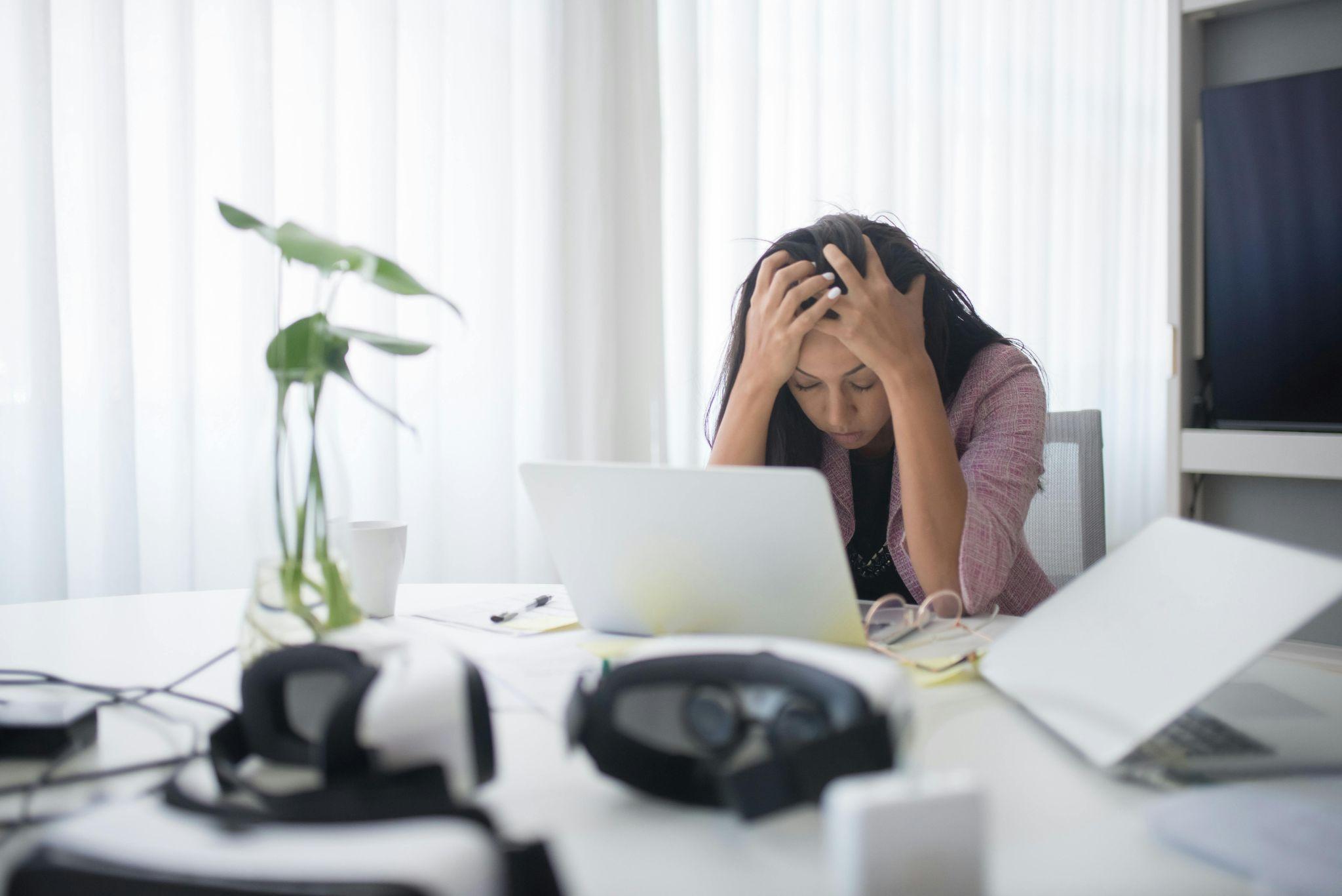 A stressed employee struggling with a slow or failing computer